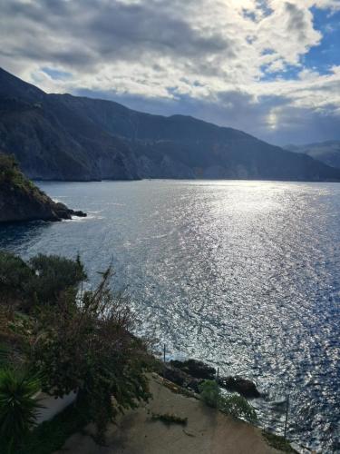 a large body of water with mountains in the background at Asos Luxury Seafront Villas, Kefalonia, 100m beach & center, 4 stars services, Parking - near Myrtos - Fiskardo in Asos