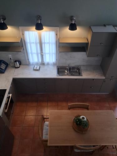 an overhead view of a kitchen with a wooden table at Asos Luxury Seafront Villas, Kefalonia, 100m beach & center, 4 stars services, Parking - near Myrtos - Fiskardo in Asos