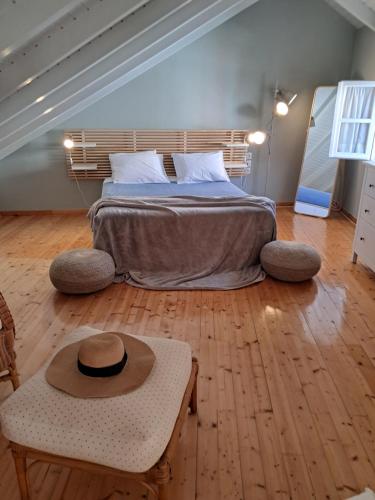 a bedroom with a bed with a hat on it at Asos Luxury Seafront Villas, Kefalonia, 100m beach & center, 4 stars services, Parking - near Myrtos - Fiskardo in Asos