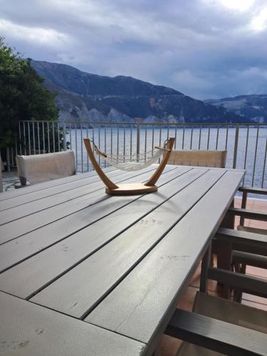 a wooden table with a hammock on top of the water at Asos Luxury Seafront Villas, Kefalonia, 100m beach & center, 4 stars services, Parking - near Myrtos - Fiskardo in Asos