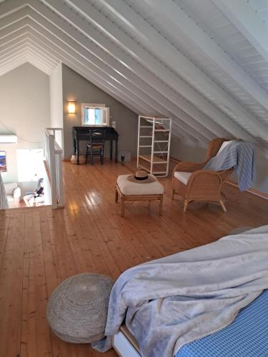 a attic room with a bed and a piano at Asos Luxury Seafront Villas, Kefalonia, 100m beach & center, 4 stars services, Parking - near Myrtos - Fiskardo in Asos
