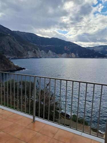 a view of a body of water from a balcony at Asos Luxury Seafront Villas, Kefalonia, 100m beach & center, 4 stars services, Parking - near Myrtos - Fiskardo in Asos
