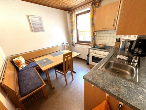 a small kitchen with a table and a sink at Haus Troger in Sankt Jakob in Defereggen