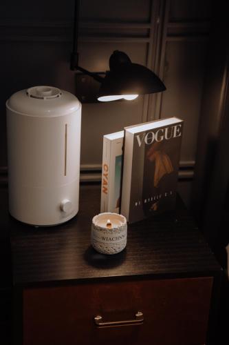 a table with a food processor and a book and a candle at Lakeside Retreat - LuguLake Lijiang in Zuosuo