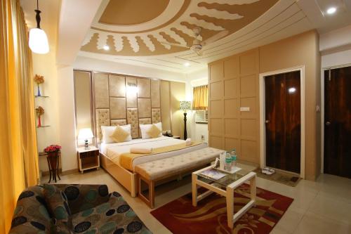 a hotel room with a bed and a couch at Hotel Opera Delhi International Airport in New Delhi