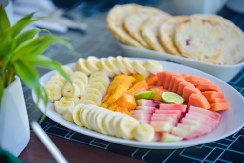 a plate of fruit and vegetables on a table at The Residence Ella in Ella