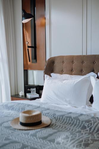 a hat is sitting on top of a bed at Lakeside Retreat - LuguLake Lijiang in Zuosuo