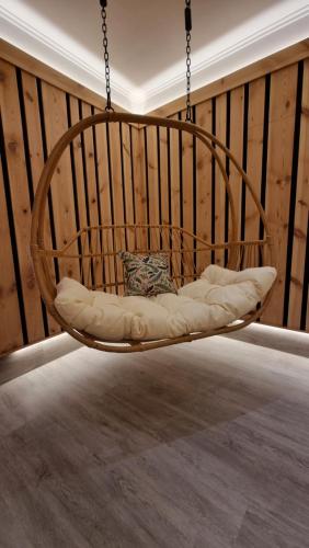 a swing in a room with a wooden wall at Posers Bergwelt B&B in Schladming