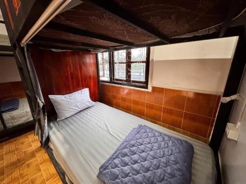 a bedroom with a bed in a room with at Jungle Backpackers View in Vang Vieng