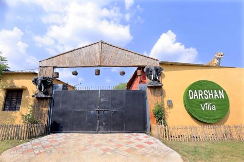 a black garage door in front of a building at Darshan Villa in Thūr