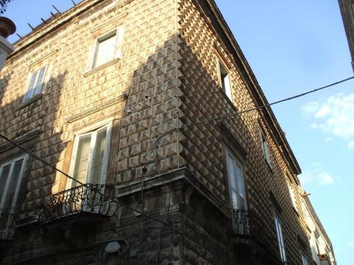 a brick building with windows on the side of it at A Soqquadro in Bisceglie