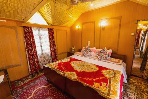 a bedroom with a large bed in a room at Dilnaaz group of houseboats in Srinagar