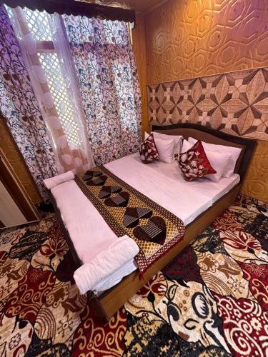 a bedroom with a bed with shoes on it at Dilnaaz group of houseboats in Srinagar
