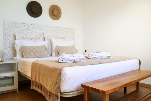 a bedroom with a bed with two towels on it at Seashore Villa - Porto Santo in Porto Santo
