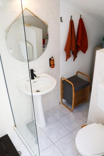 a bathroom with a sink and a mirror at Seashore Villa - Porto Santo in Porto Santo
