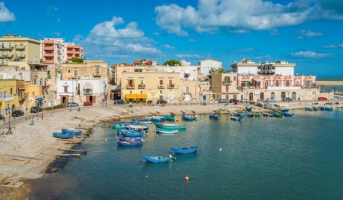 a group of boats in the water next to buildings at A Soqquadro in Bisceglie