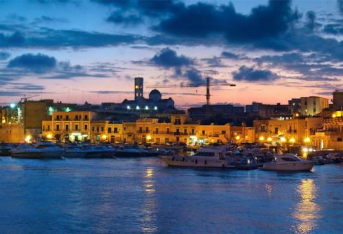 a group of boats docked in a harbor at night at A Soqquadro in Bisceglie