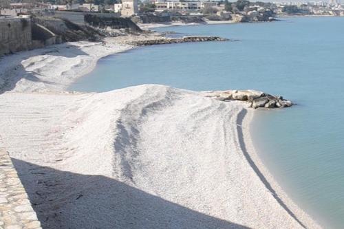 a rock in the middle of a body of water at A Soqquadro in Bisceglie