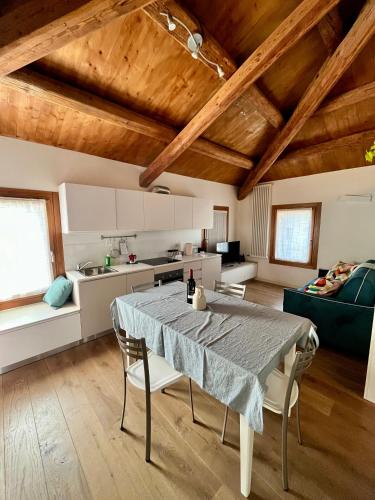 a kitchen and living room with a table and chairs at C'era una volta un mulino in Conegliano