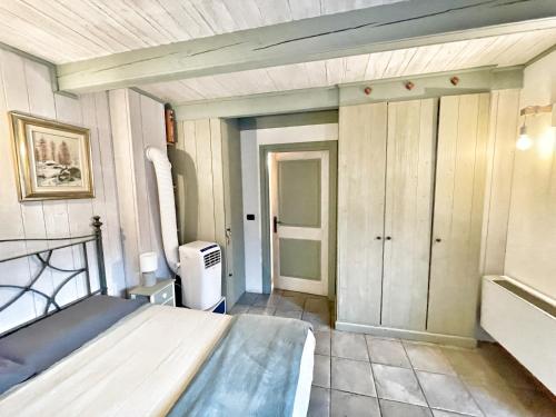 a small room with a bed and a closet at La Casina di Oscar ad AO V Combe VDA QUART 0014 e 00I6 in Quart