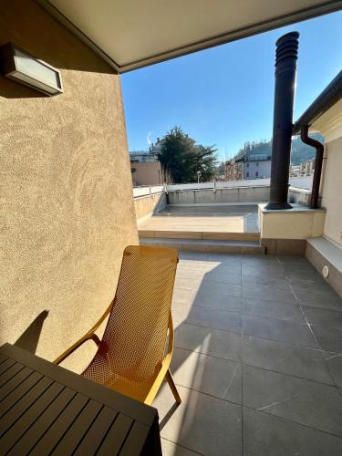 a patio with a chair and a bench on a balcony at C'era una volta un mulino in Conegliano