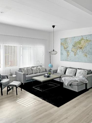 a living room with a couch and a table at Lyxig Stadsro och Utrymme villa i Malmö in Malmö