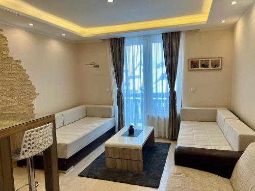 Ένα ή περισσότερα κρεβάτια σε δωμάτιο στο Vila Kopaonik Apartmani Milenkovic