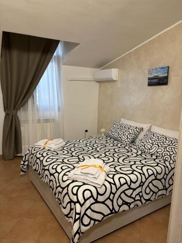 a bedroom with a black and white bed and a window at Del Golfo House in Angri