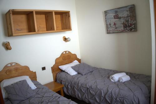 a room with two beds and a cabinet at Résidence Montana Premier in Val Thorens