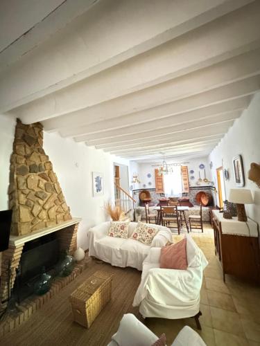 a living room with a couch and a fireplace at Villa rural sXIX Luz tranquilidad y naturaleza in Blanca