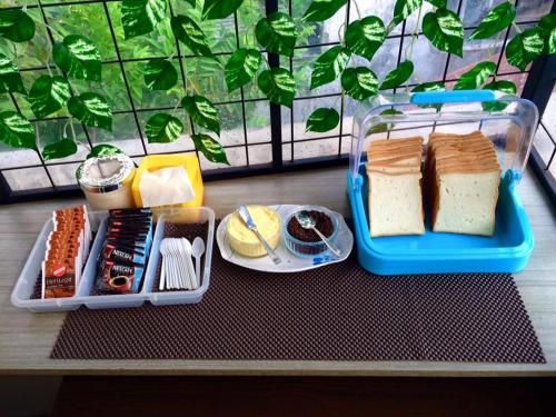 a lunch box with cheese and other foods on a table at Hotel Pules in Yogyakarta