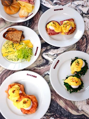 a group of plates of food on a table at The Hoxton Vienna in Vienna
