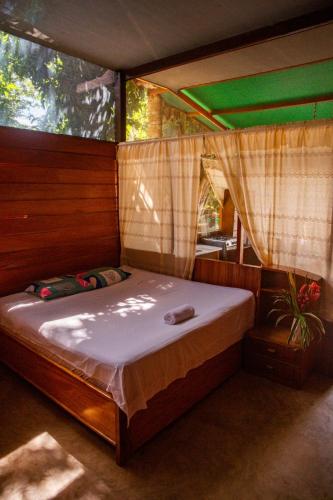 a bedroom with a bed in a tent at Coco house tambopata in Puerto Maldonado