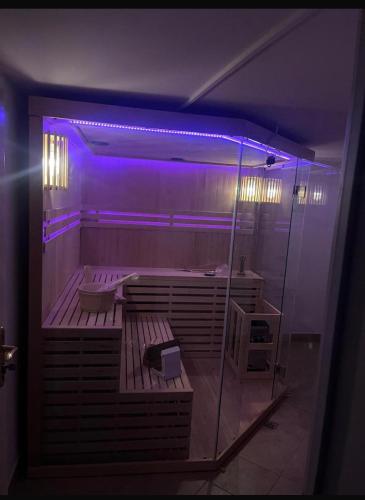 a large bathroom with a tub with purple lights at B-Willa Słopnice basen & jacuzzi, sauna in Słopnice