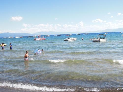 a group of people in the water at the beach at Firelite Lodge in Tahoe Vista