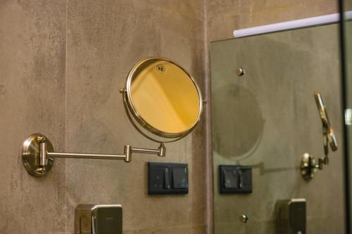 a mirror on a wall in a bathroom at The Cube in Kegalle