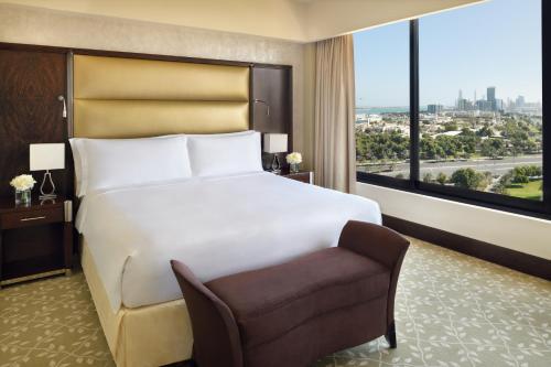 a hotel room with a large bed and a chair at InterContinental Abu Dhabi by IHG in Abu Dhabi