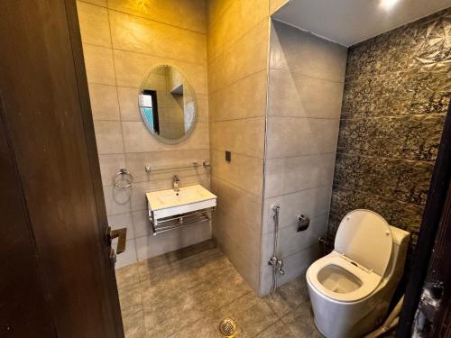 a bathroom with a toilet and a sink at Bridge Residency-2 Top City-1 Islamabad in Islamabad
