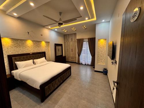 a bedroom with a large bed in a room at Bridge Residency-2 Top City-1 Islamabad in Islamabad