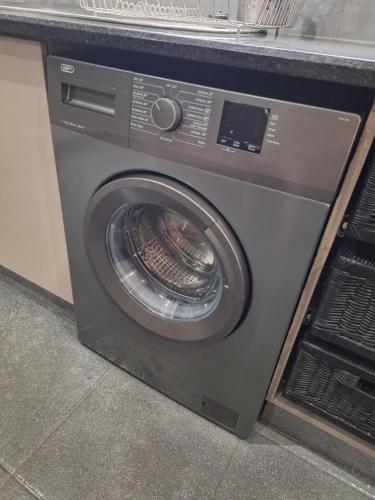 a washing machine with its door open on a counter at Studio 4 The Studios at Churchill in Hillcrest