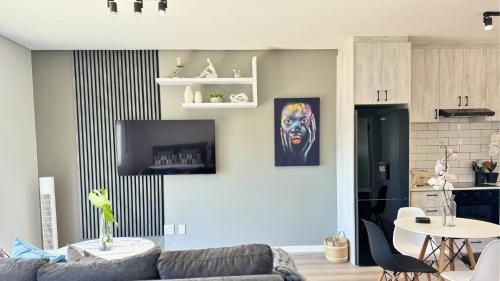a living room with a couch and a table at Obs Centre Luxe Loft in Cape Town