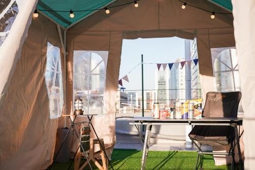 a tent with a table and chairs in it at Mutal Stay in Seoul