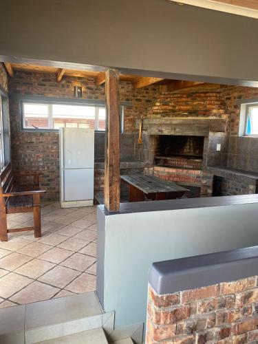 a kitchen with a counter and a brick wall at Adventure House - Colchester - 5km from Elephant Park in Colchester