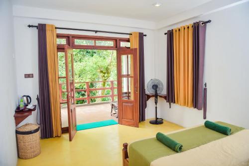 a living room with a couch and a sliding glass door at The Residence Ella in Ella