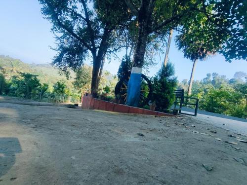 a park bench sitting on the side of a road at PADAVAYAL GREENS in Attappādi