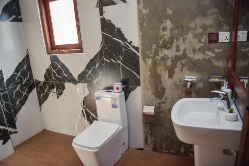 a bathroom with a toilet and a sink at The Residence Ella in Ella