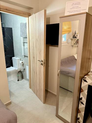 a small room with a door open to a bedroom at Mini Luxe Retreat in Volos