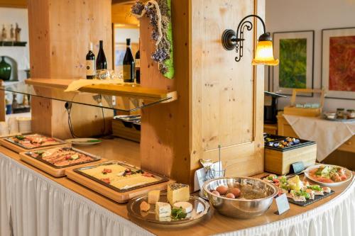 a buffet with many different types of food on a table at Panoramahotel Grobauer in Spiegelau