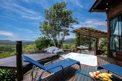 a patio with a hot tub and tables and chairs at Riviera Santo Antônio in Florianópolis