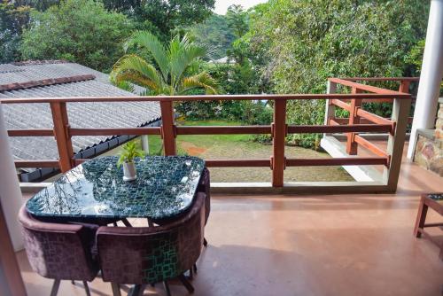 a balcony with a table and a plant on it at The Residence Ella in Ella